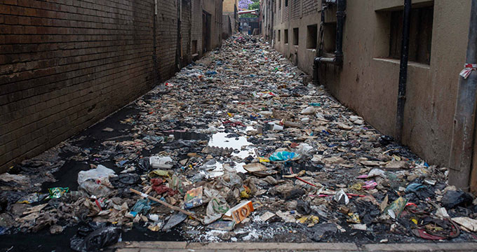 Rubbish lies between residential buildings in Hillbrow.