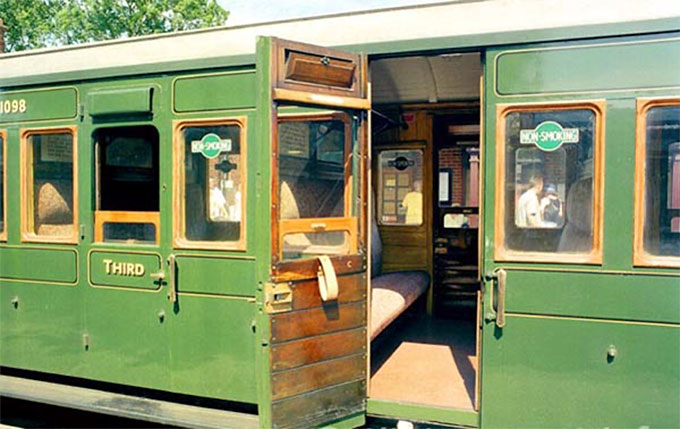 The long seat of a coach compartment in a British train of the period.